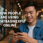 Young man using smartphone in a public space, exploring GreatBasinExp57 online.